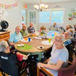 Residents gathered in dining area celebrating a birthday 